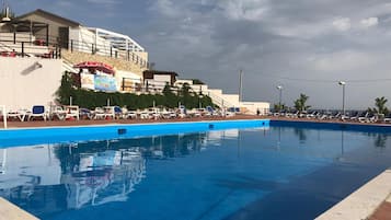 Outdoor pool, open 9:00 AM to 7:00 PM, pool umbrellas, sun loungers