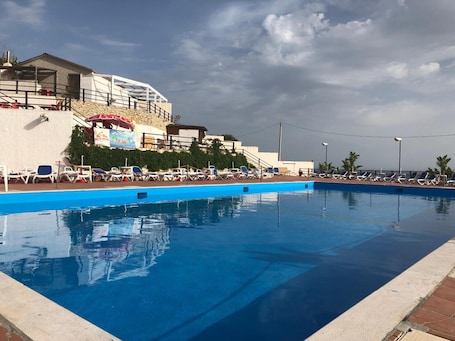 Outdoor pool, open 9:00 AM to 7:00 PM, pool umbrellas, sun loungers