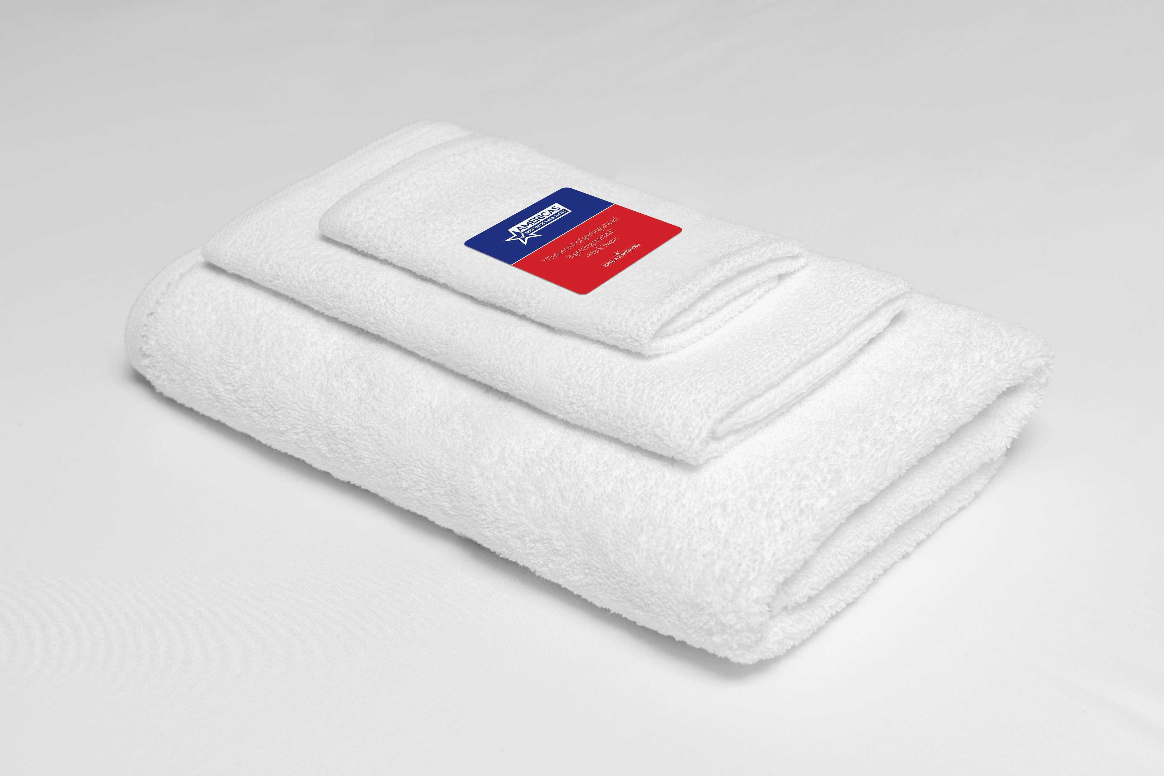 A neatly folded white towel with a label.