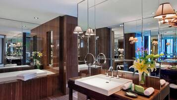 A modern bathroom with a large mirror, a sink, and a vanity.
