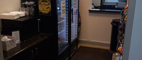 A hotel room with a minibar, a refrigerator, and a window.