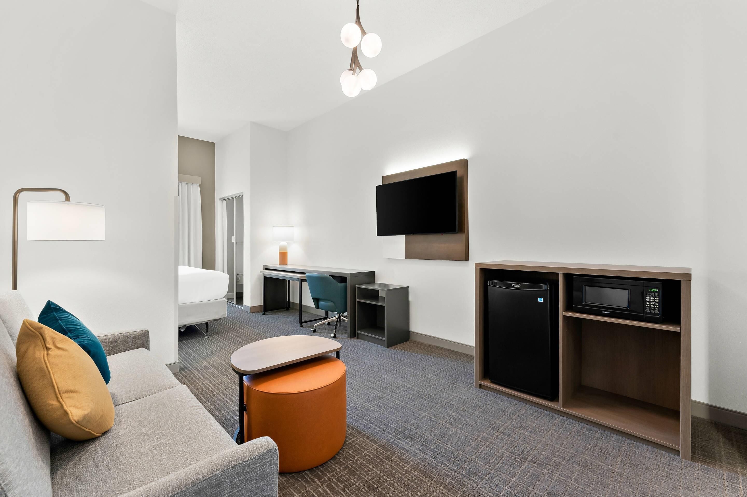 Suite, 1 King Bed, Accessible, Non Smoking (Roll In Shower) | In-room safe, desk, laptop workspace, iron/ironing board