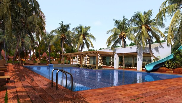 A pool area with lounge chairs, a slide, and palm trees.