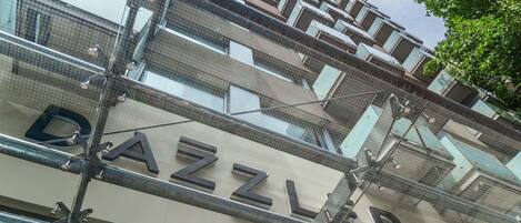 A multi-story building with a visible 'DAZZLER' sign, indicating a commercial establishment.