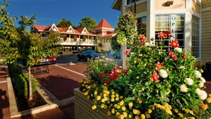A hotel with a red roof, a balcony, and a sign indicating it's open. - Silverton Inn & Suites (Silverton)