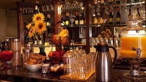 A bar area with shelves of wine bottles, glasses, and a coffee machine. - Silverton Inn & Suites (Silverton)