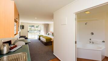 Studio, Jetted Tub | Premium bedding, Select Comfort beds, desk, soundproofing