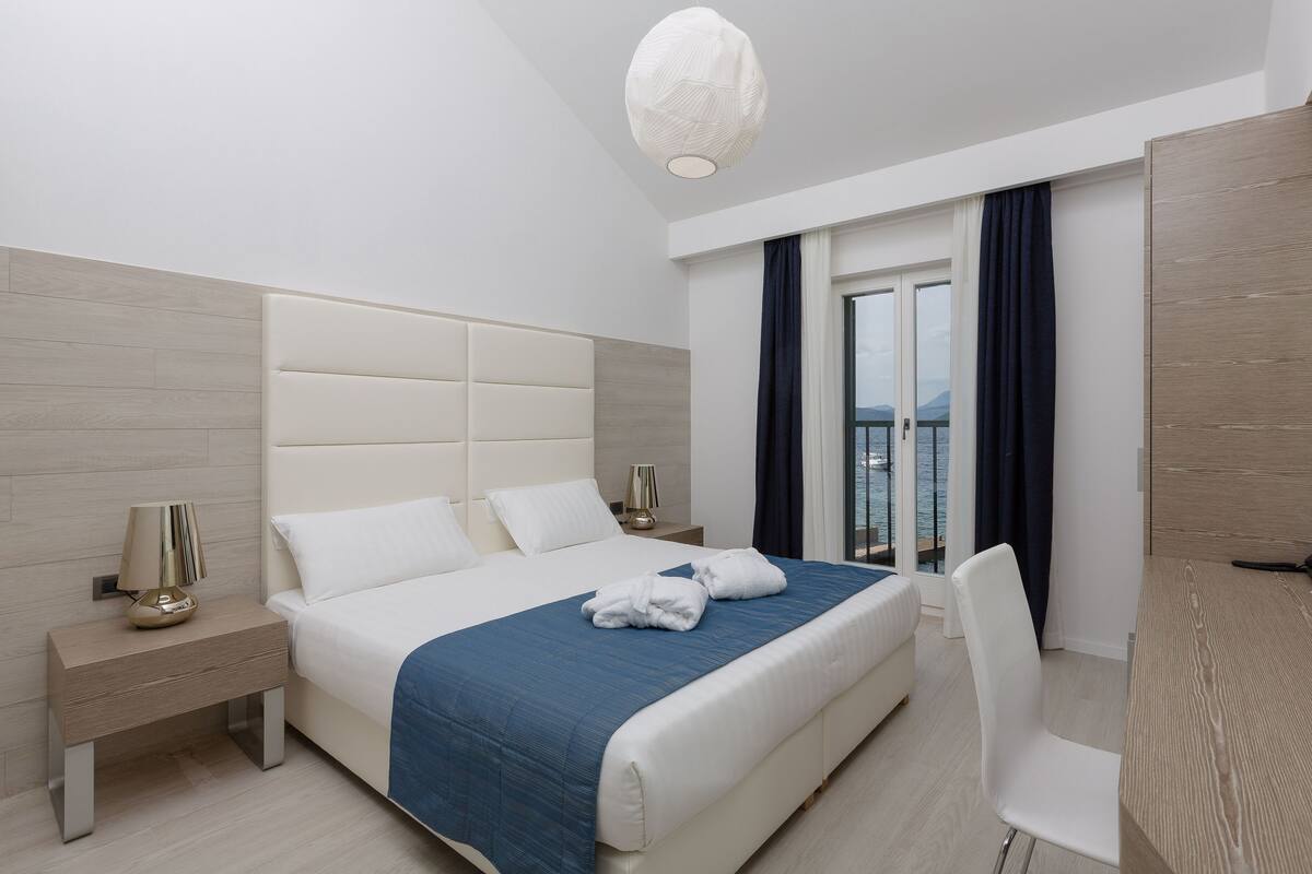 Apartment, Terrace, Sea View | Minibar, in-room safe, desk, blackout drapes