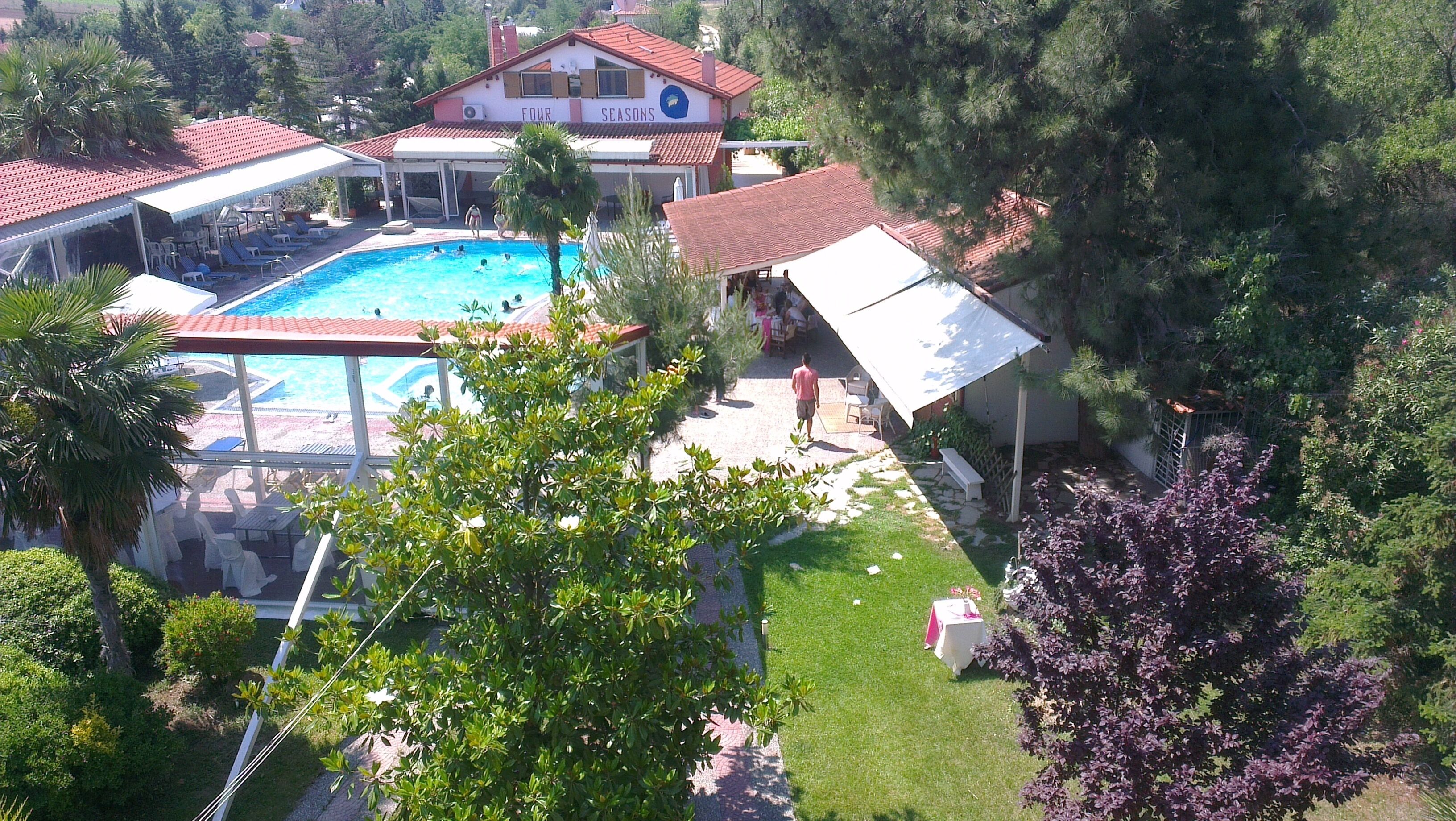 Une propriété résidentielle dotée d’une piscine, d’un patio couvert et d’un jardin.