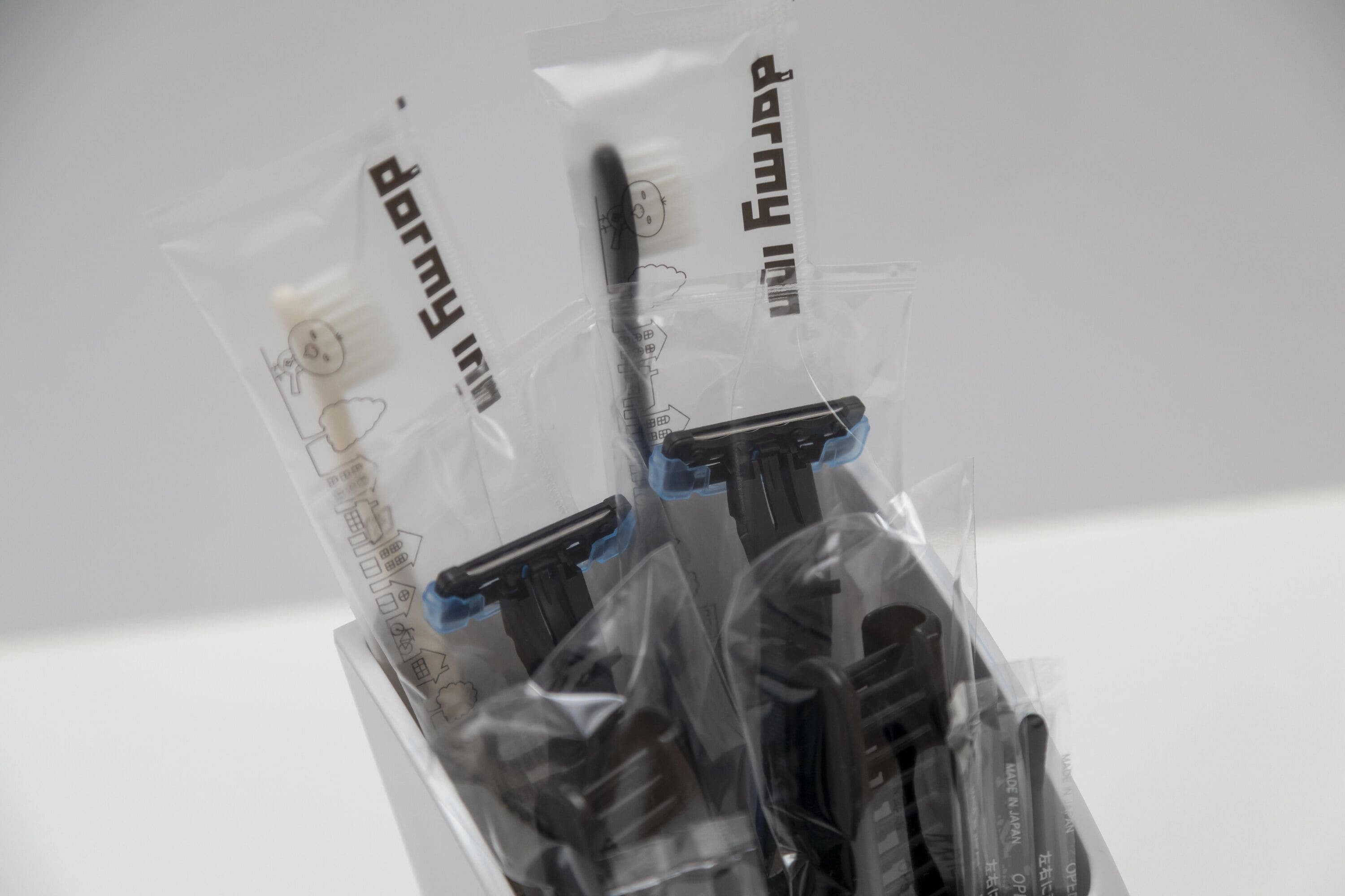 A plastic bag containing a black object with blue tape, labeled 'dorm'.