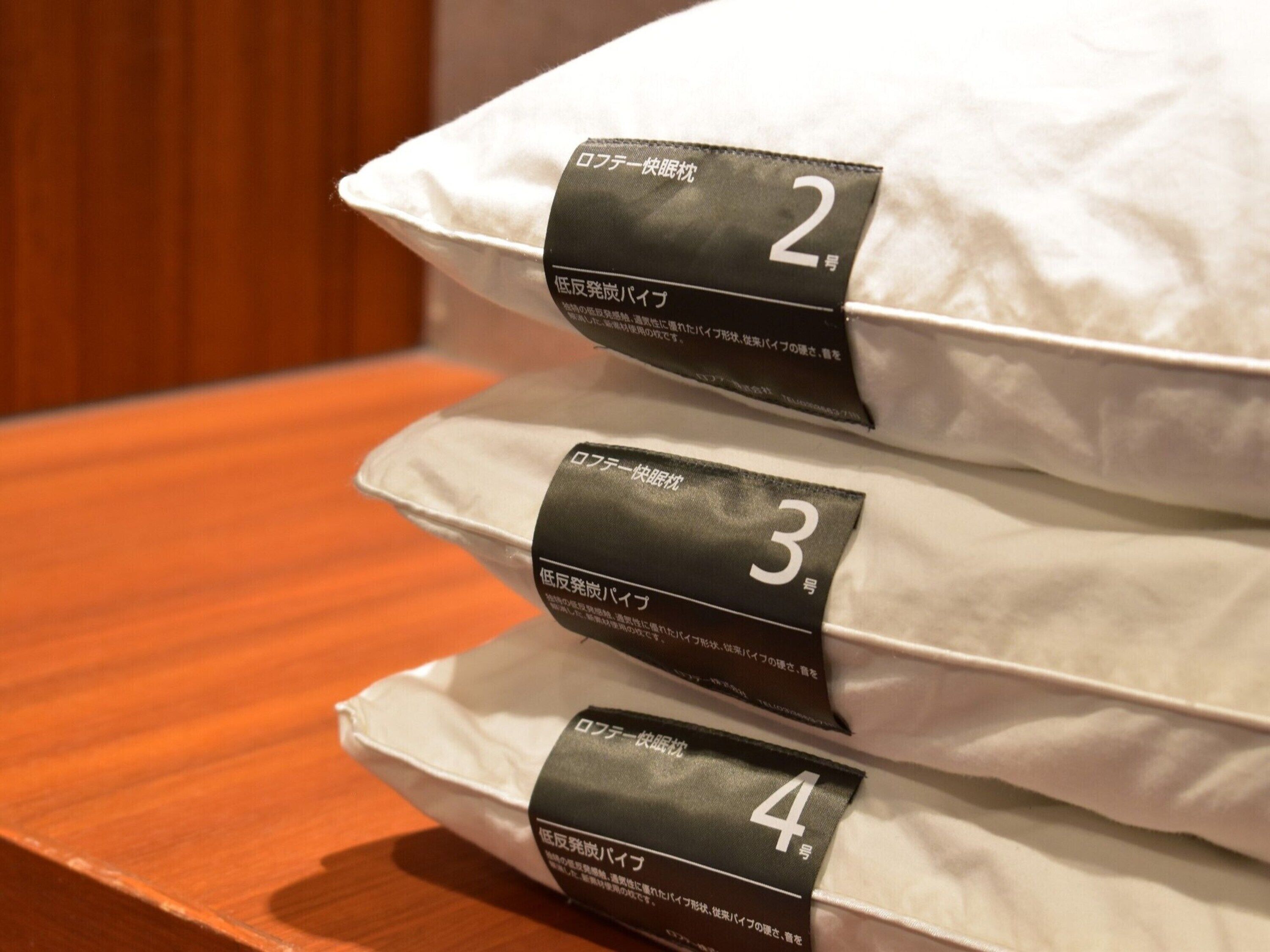A stack of pillows with labels indicating sizes 2, 3, and 4.