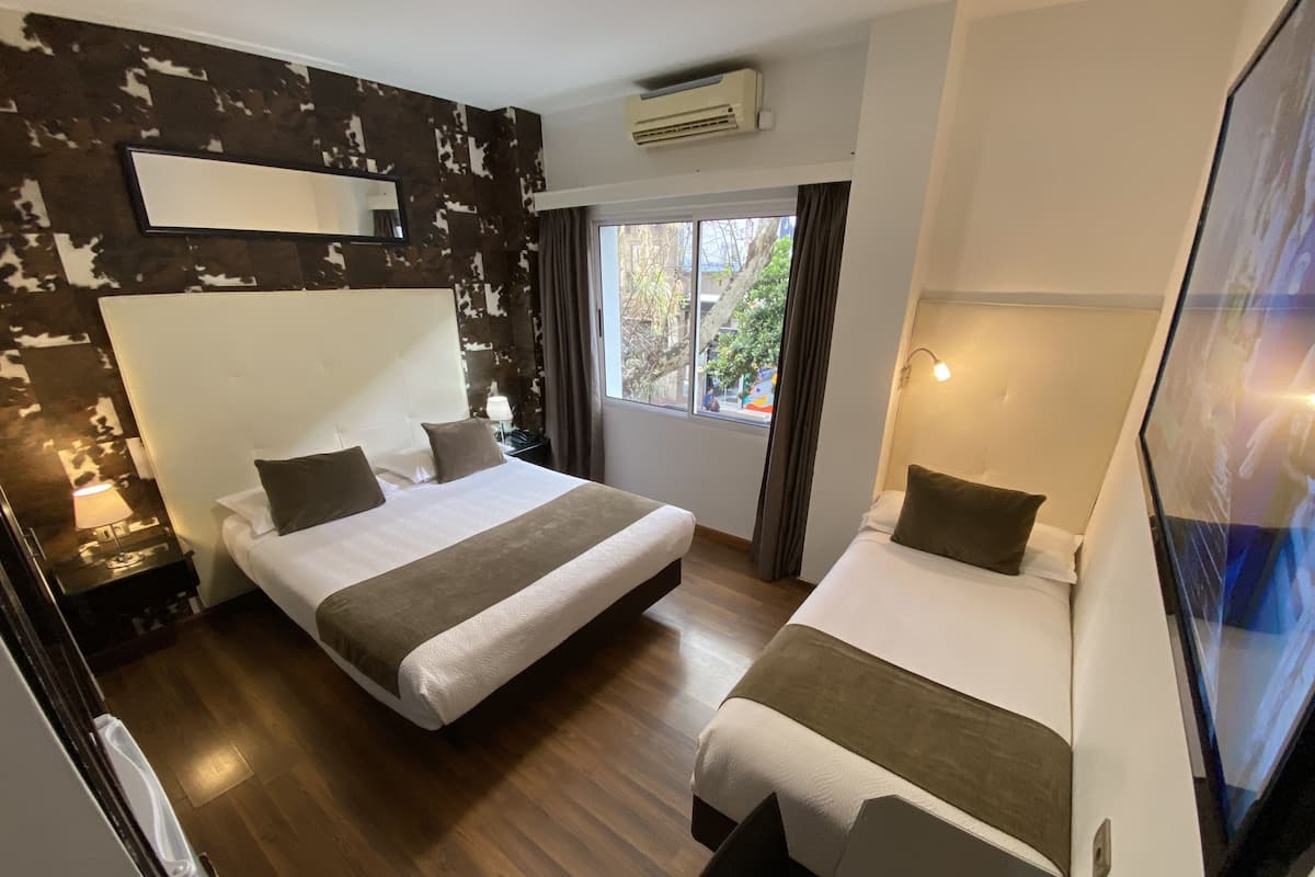 Triple Room | Minibar, in-room safe, individually furnished, desk