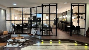 A modern interior with a dining area, kitchen, and seating space. - Alvear Hotel (Montevideo)