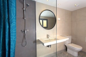 A modern bathroom with a glass-enclosed shower, a white sink, and a toilet. - Villa Saint Exupéry Beach - Hostel (Nice)