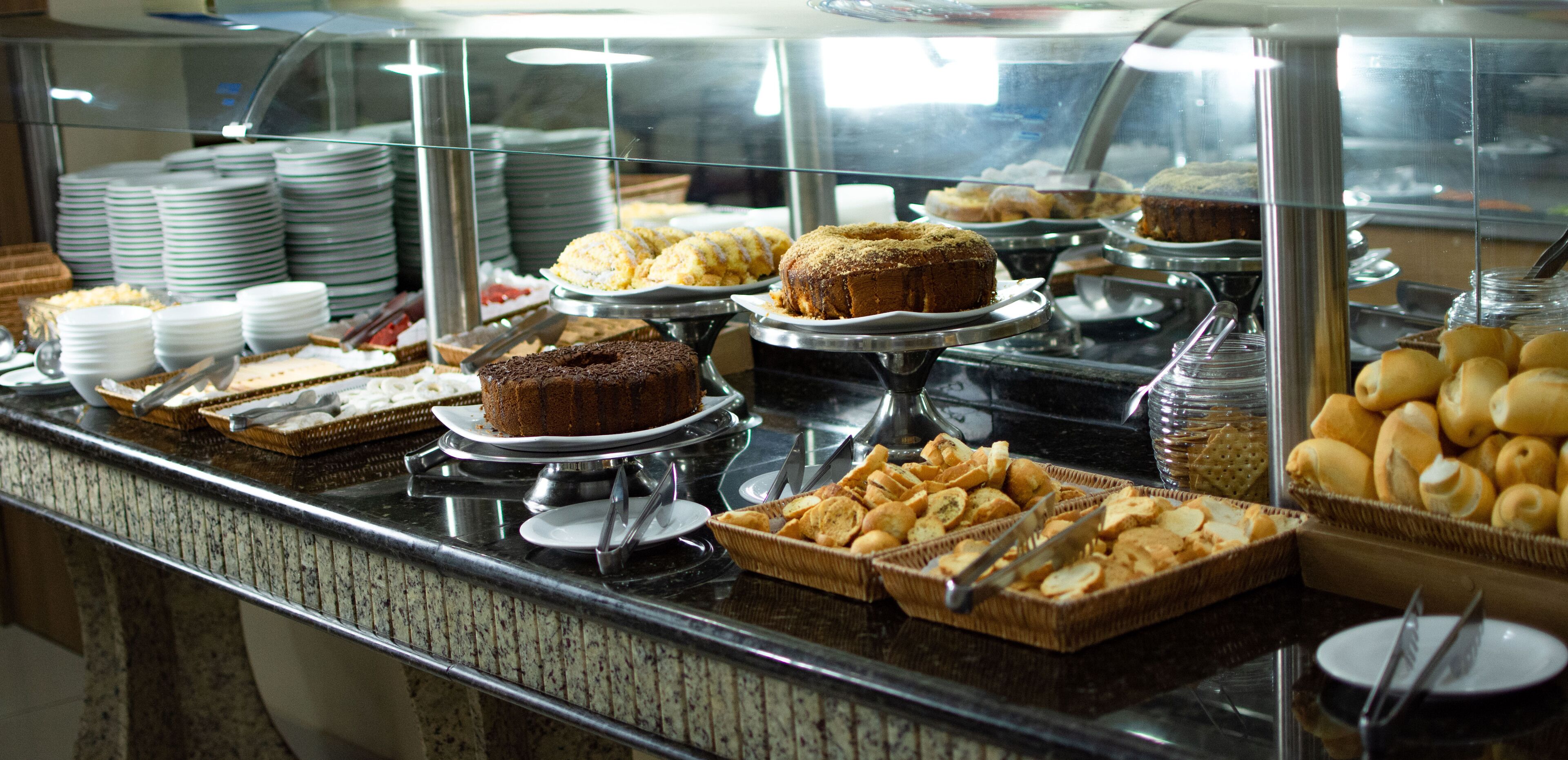 A buffet with various baked goods and pastries.