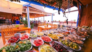 A buffet with various food items and utensils.