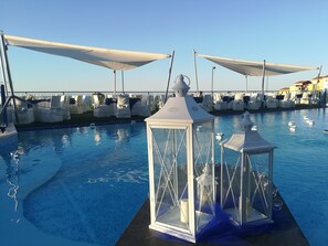 A pool area with white canopies and lanterns. - Tus' Hotel (Tusa)