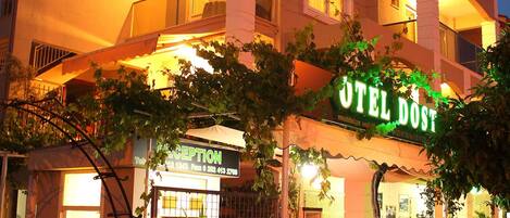 A hotel with a reception area, a gated entrance, and a balcony.