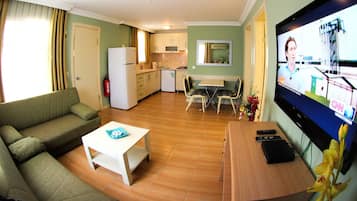 Family Apartment, 2 Bedrooms | Living room | 22-inch LCD TV with premium channels, TV