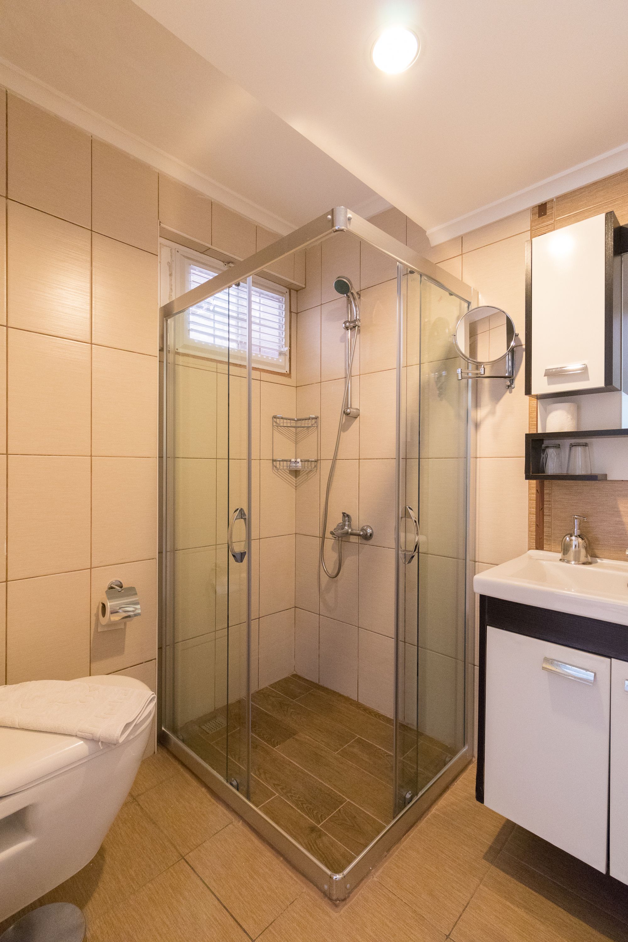 shower, hair dryer, slippers, towels