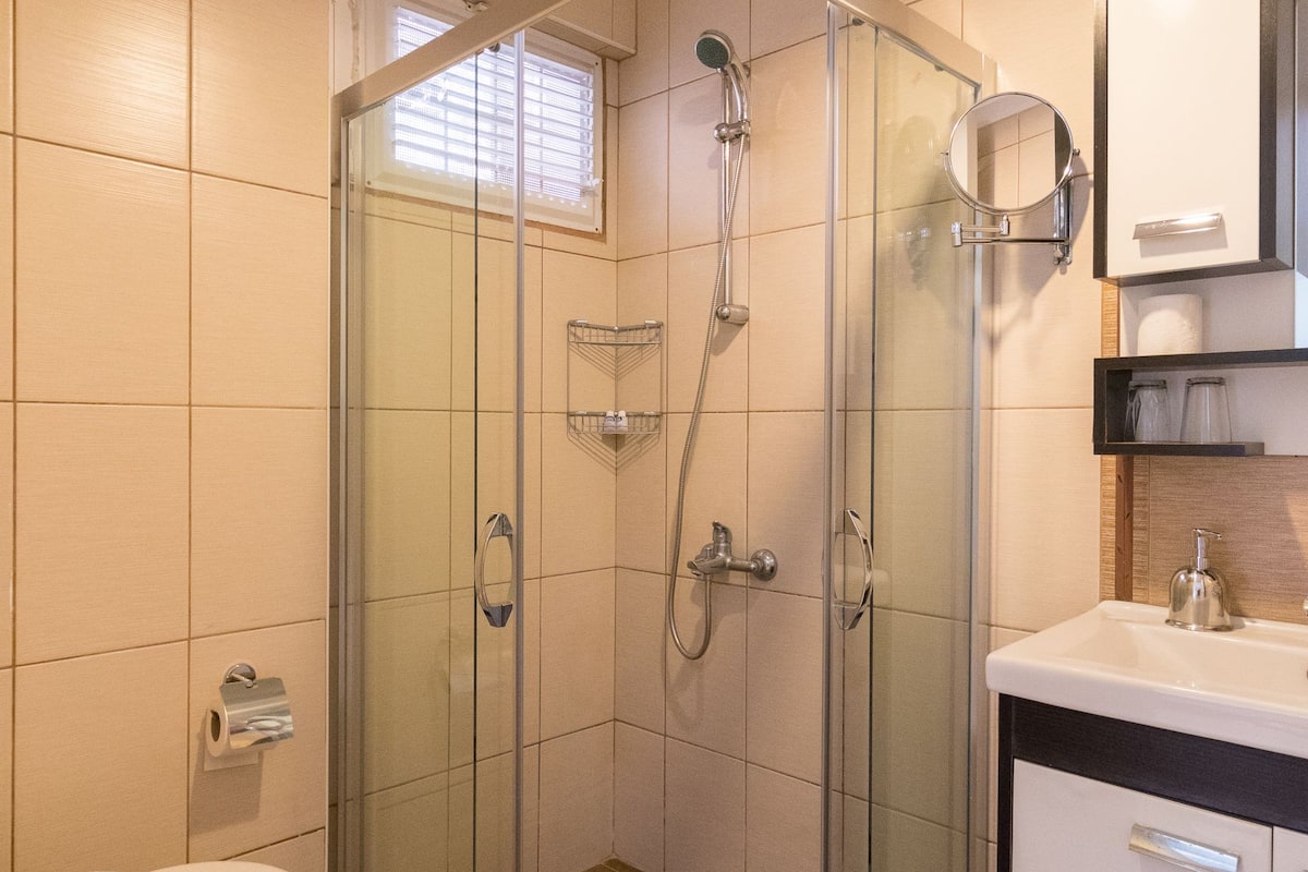 shower, hair dryer, slippers, towels