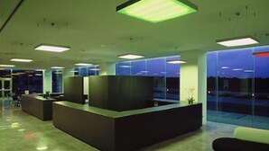 A modern reception area with a central desk, glass partitions, and a view of the outside. - Hotel Duomo (Benifayo)