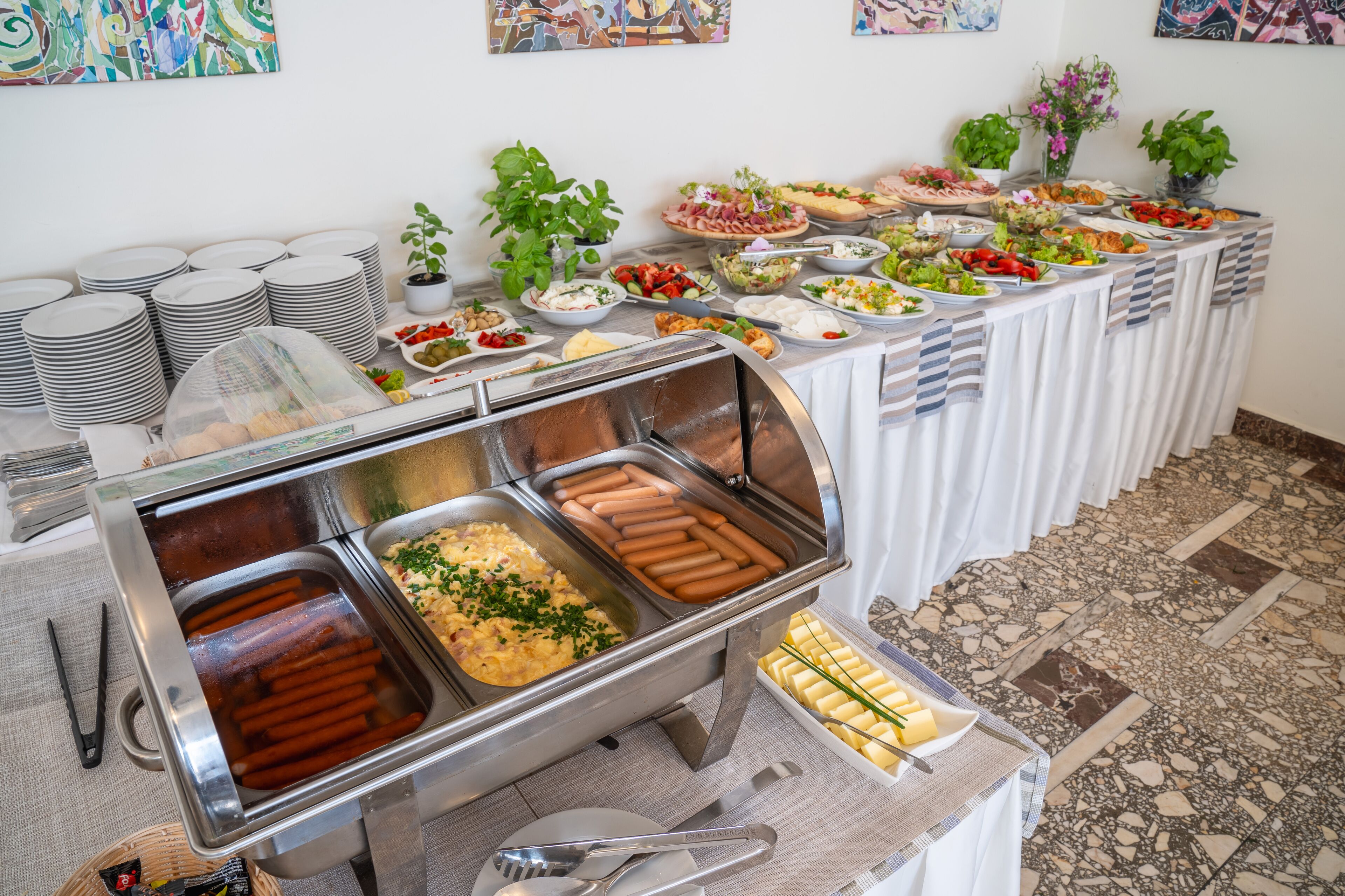 A buffet with various food items, including hot dogs, salads, and a variety of other dishes.