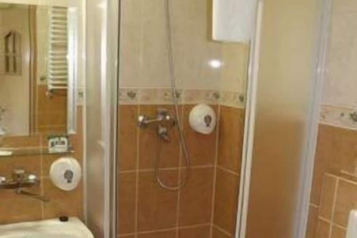 A bathroom with a shower, sink, and toilet.