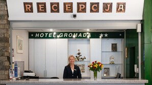A reception desk with a sign reading "RECEPTION HOTEL GROMADA". - Hotel Gromada Zakopane (Zakopane)