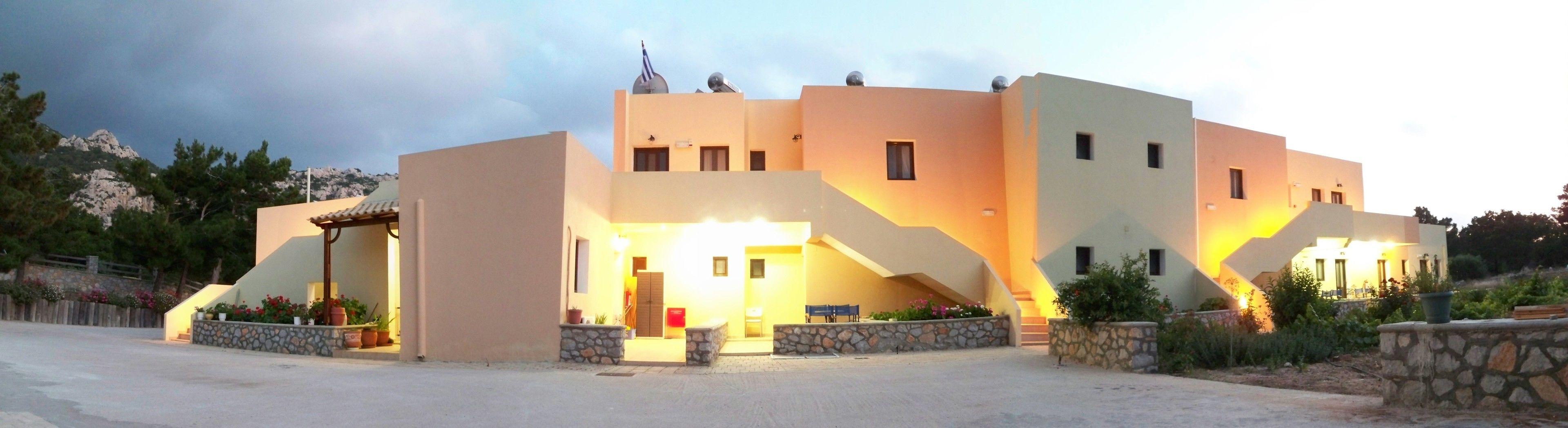 A modern building with a unique architectural design, featuring multiple levels and a prominent staircase.