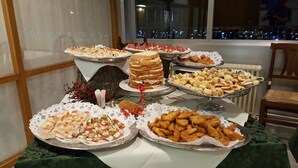 A buffet table with various food items including sandwiches, pastries, and appetizers. - Hotel Sole Alto (Mezzana)
