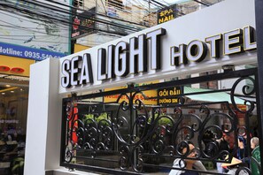 A hotel sign with the name "SEA LIGHT HOTEL" and a contact number. - Sea Light Hotel (Nha Trang)