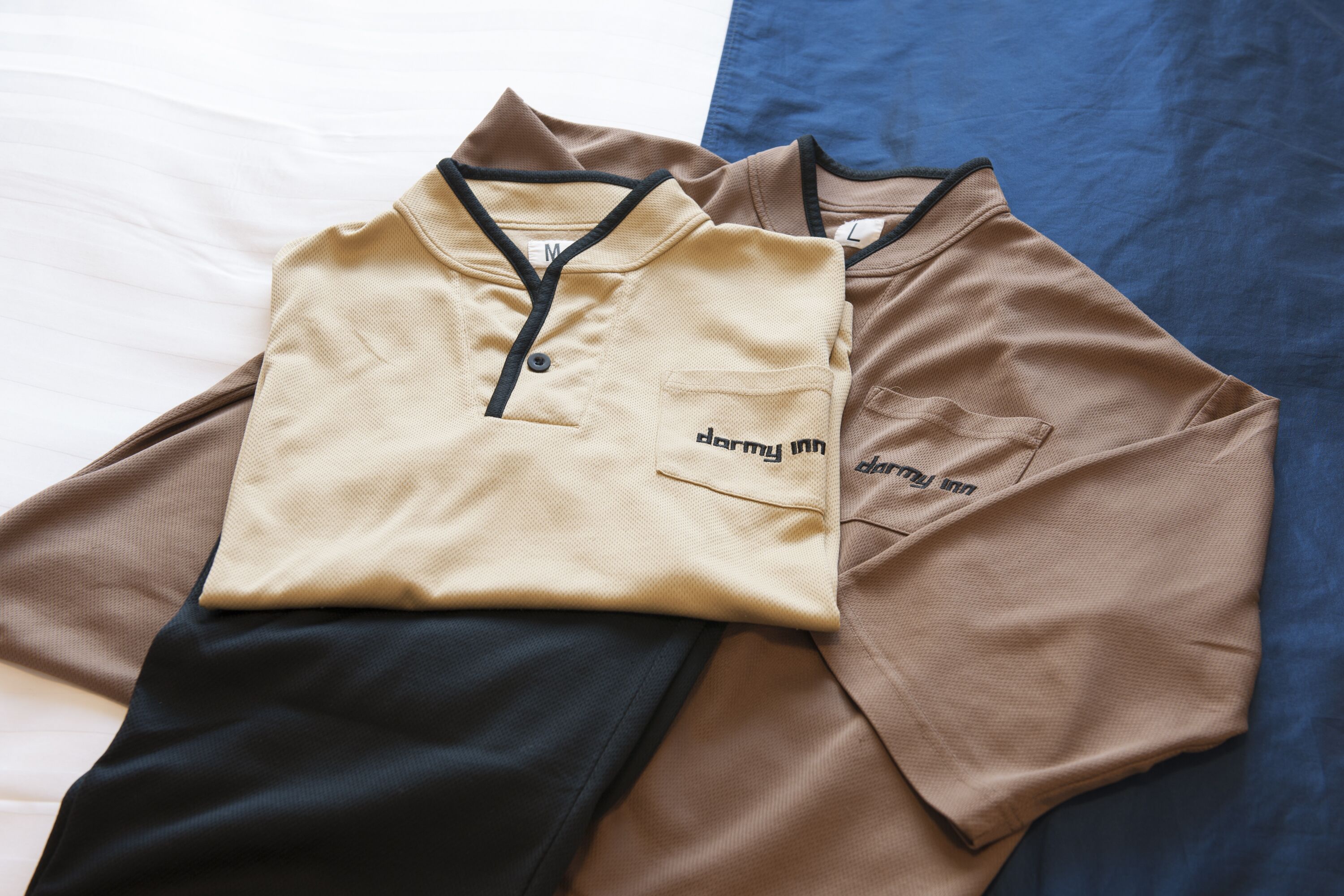 A neatly folded set of clothing on a bed.