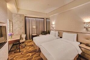 A hotel room with two beds, a desk with a chair, a TV, and a decorative wall panel. - Capital Hotel Nanjing (Taipei)