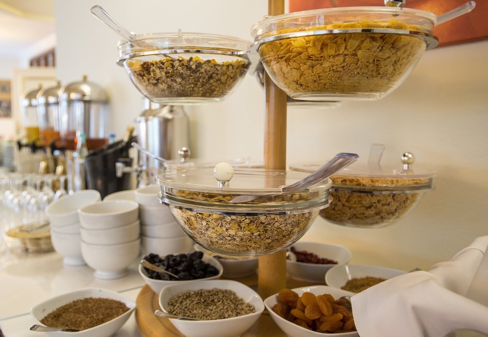 A buffet setup with various food items in bowls and containers.