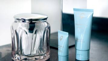 A clear glass jar, a blue tube, and a box on a countertop.