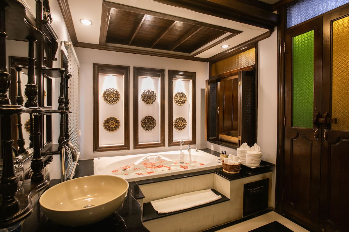 luxury king bed with spa bath and private balcony | bathroom | separate bathtub and shower, rainfall showerhead, hair dryer, bathrobes