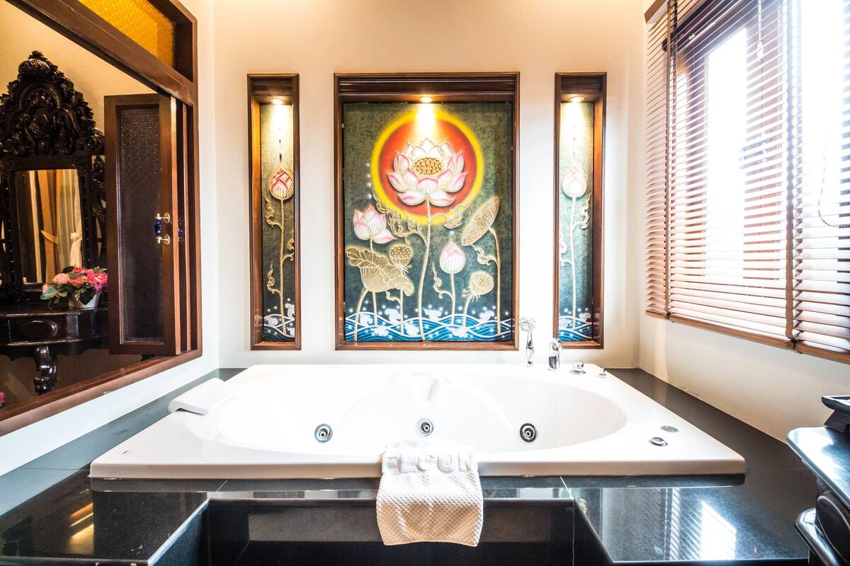 lanna junior suite king bed with spa bath | bathroom | separate bathtub and shower, rainfall showerhead, hair dryer, bathrobes