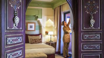 A hotel room with a bed, a nightstand, and a window with curtains.