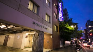 Accessible entrance with a prominent door and sign, set amidst a bustling urban area.