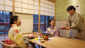 Experience the tranquility of a traditional Japanese room with tatami flooring and sliding shoji doors, offering a serene view of a traditional building.
