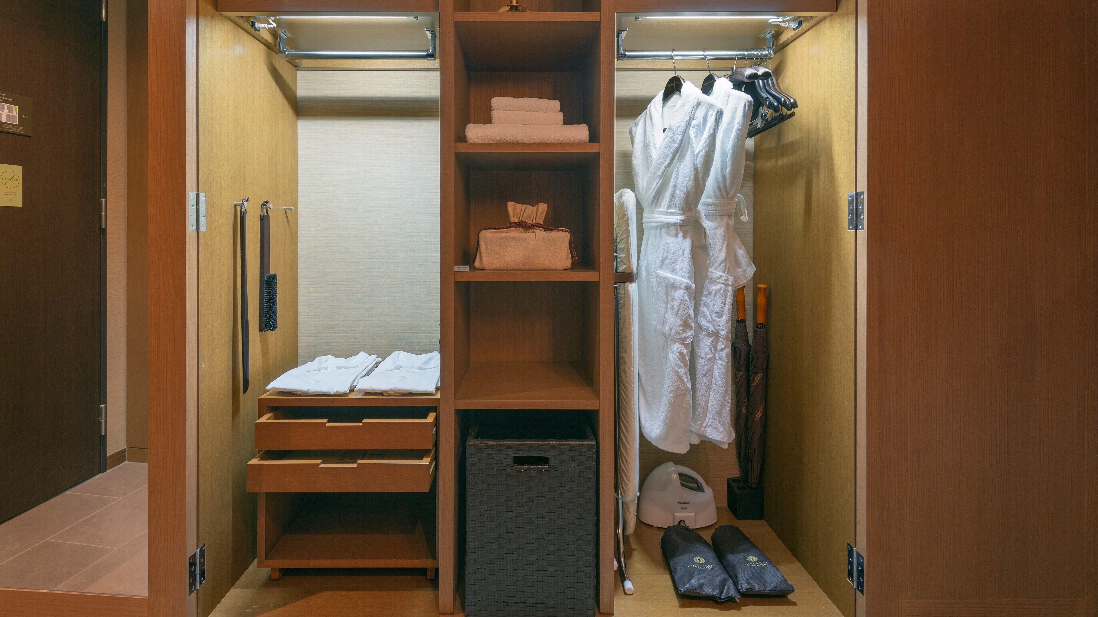 A walk-in closet with multiple shelves, a hanging rack, and a shoe rack.