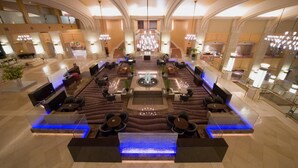 A spacious lobby with a central seating area, a grand staircase, and a modern chandelier. - The Windsor Hotel Toya, Vignette Collection by IHG (Toyako)