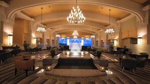 A spacious lobby with a central fountain, multiple seating areas, and elegant chandeliers. - The Windsor Hotel Toya, Vignette Collection by IHG (Toyako)