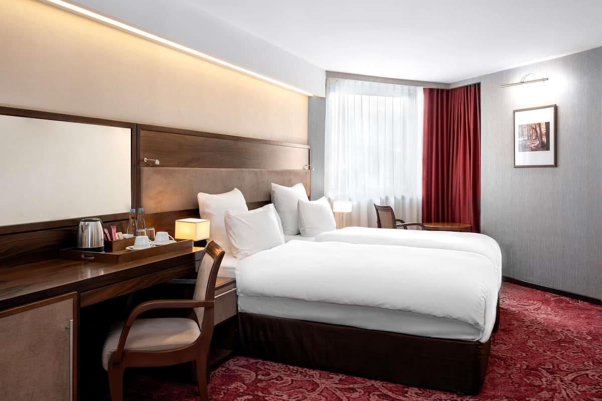 Deluxe Twin Room, Multiple Beds | Minibar, in-room safe, desk, soundproofing