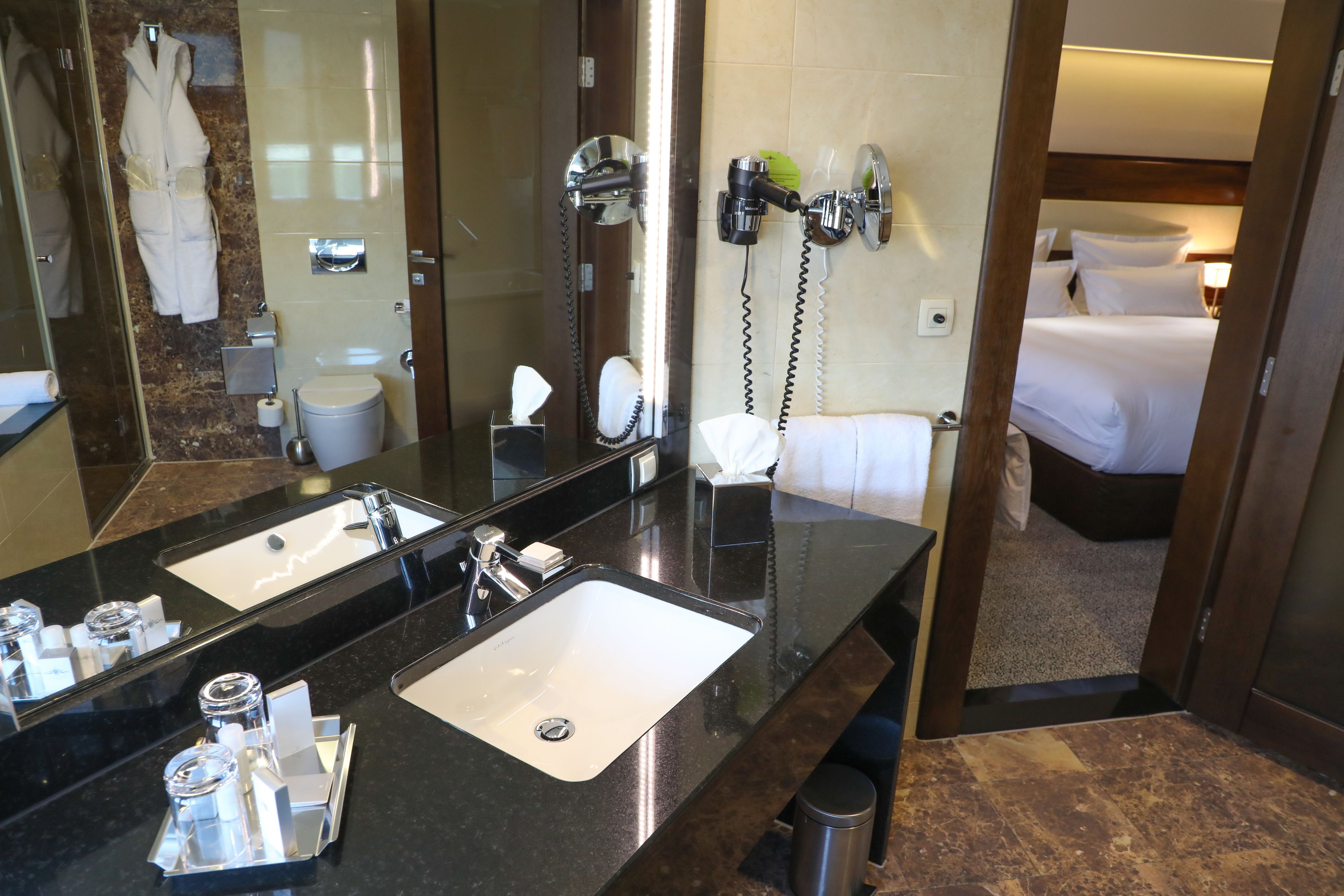 deluxe room, 1 king bed | bathroom | eco-friendly toiletries, hair dryer, slippers, towels