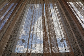 A view of a room with a patterned floor and a window with a view of the sky. - Movenpick hotel Sarajevo (Sarajevo)