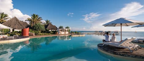 Outdoor pool, pool umbrellas, sun loungers