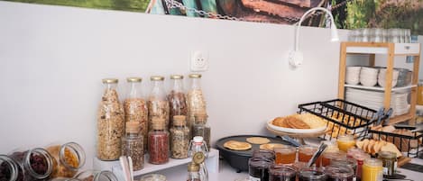 A breakfast buffet with various food items and condiments.