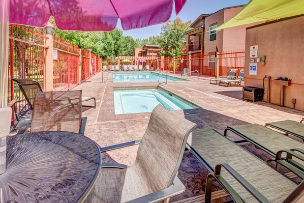 Seasonal outdoor pool, open 9:00 AM to 10:00 PM, pool umbrellas